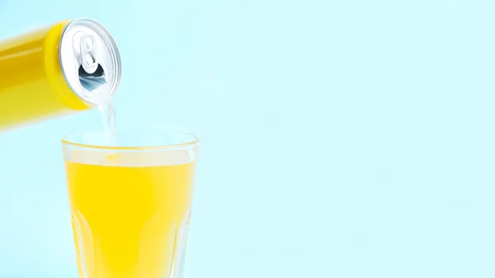 pouring yellow canned beverage