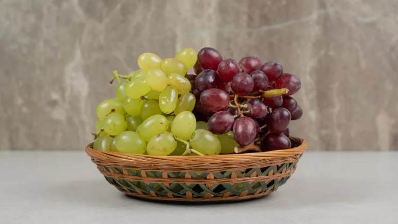 red and green grapes in basket