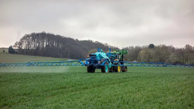 tractor pesticide application in field