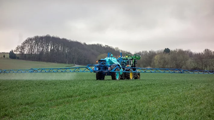tractor pesticide application in field