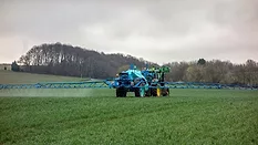 tractor pesticide application in field