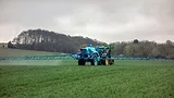 tractor pesticide application in field