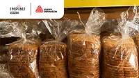 bags of fresh bread on a store shelf