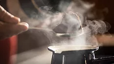 instant coffee_kerry group.png spoonful of instant coffee above a steaming mug