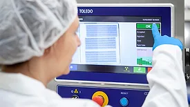 operator using mettler toledo inspection equipment