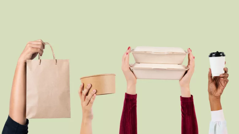 hands holding up single-use paper food packaging items