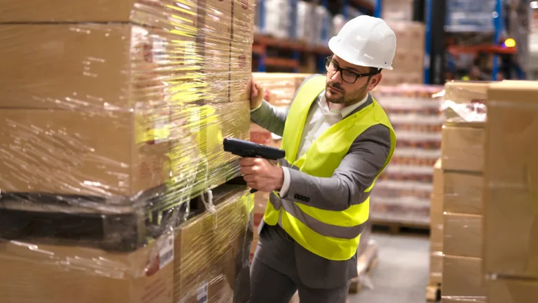 man holding barcode scanner in warehouse