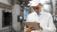 technologist using tablet in food production facility
