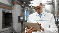technologist using tablet in food production facility