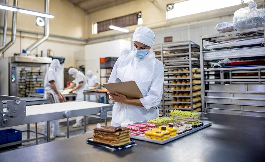 woman inspecing baked goods commercial bakery