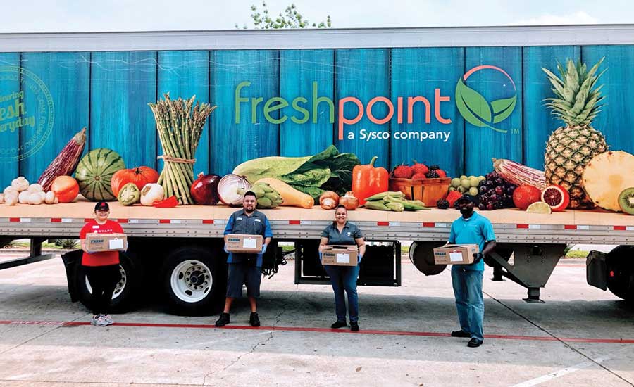 a truck and people holding produce